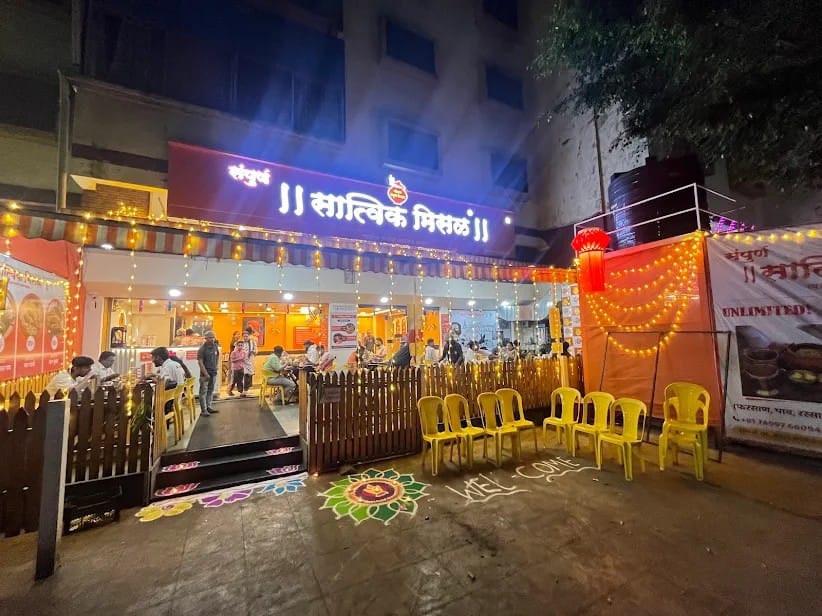 Sampurn Satvik Misal outlet lit up with festive lights in the evening