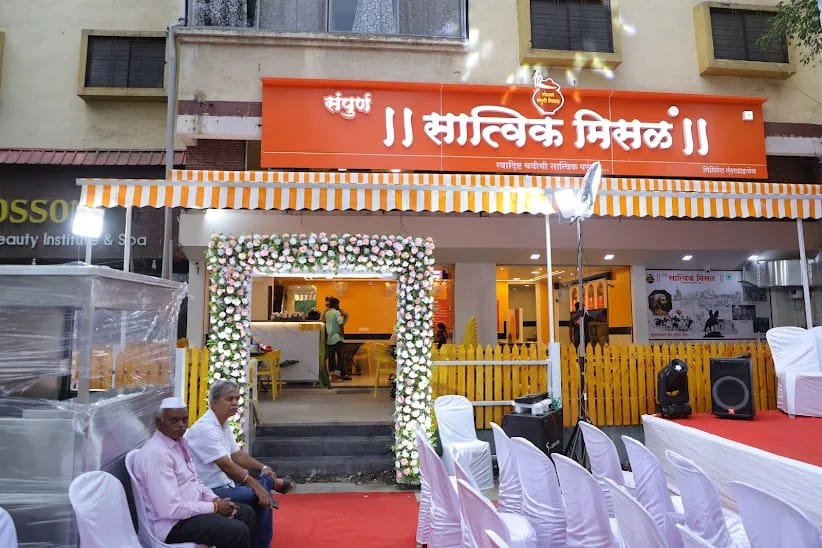 Sampurn Satvik Misal franchise outlet entrance decorated with a flower arch on launch day